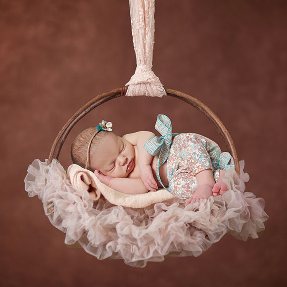 Newborn in peach basket